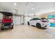 Spacious three-car garage with ample storage, housing both a golf cart and a modern SUV at 4485 River Oaks Rd, Lake Wylie, SC 29710