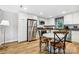 Bright kitchen with stainless steel appliances, white cabinetry, and a cozy breakfast nook at 4485 River Oaks Rd, Lake Wylie, SC 29710