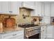 Gourmet kitchen featuring stainless steel appliances, custom cabinetry and tiled backsplash at 4485 River Oaks Rd, Lake Wylie, SC 29710