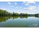 Scenic lake view featuring clear water and lush green trees under a partly cloudy sky at 4485 River Oaks Rd, Lake Wylie, SC 29710