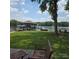 Beautiful lakeside property with a covered dock, lush green lawn, and comfortable seating, perfect for relaxing by the water at 4485 River Oaks Rd, Lake Wylie, SC 29710