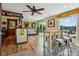 Eclectic living area featuring sports memorabilia, bar-style seating, and bright windows with scenic lake views at 4485 River Oaks Rd, Lake Wylie, SC 29710