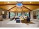 Cozy living room with a stone fireplace, vaulted wood ceiling, and panoramic lake views at 4485 River Oaks Rd, Lake Wylie, SC 29710