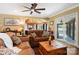 Inviting living room with a comfortable leather sofa, ceiling fan, and great natural light at 4485 River Oaks Rd, Lake Wylie, SC 29710