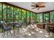 Relaxing screened porch with comfortable seating and views of the lush surrounding greenery at 4485 River Oaks Rd, Lake Wylie, SC 29710