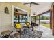 Inviting screened porch with ceiling fans, comfortable seating, and stunning lake views create a relaxing outdoor space at 4485 River Oaks Rd, Lake Wylie, SC 29710
