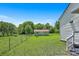 View of the backyard with a storage shed, a well-kept lawn, and chain link fence at 4555 Us 601 Hwy, Salisbury, NC 28147