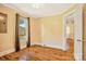 Bedroom with window, dark curtain, hardwood floor and view to hallway with door at 4555 Us 601 Hwy, Salisbury, NC 28147