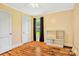 Bedroom with a ceiling fan, window and curtain, hardwood floors, and shelf unit at 4555 Us 601 Hwy, Salisbury, NC 28147