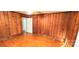 Wood-paneled bedroom with hardwood floors and view into the hallway at 4555 Us 601 Hwy, Salisbury, NC 28147