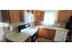 Kitchen with wooden cabinets, white appliances and linoleum countertops at 4555 Us 601 Hwy, Salisbury, NC 28147