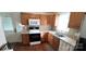 Kitchen with wooden cabinets, white appliances, and linoleum countertops; wood floors throughout at 4555 Us 601 Hwy, Salisbury, NC 28147