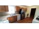 Kitchen with stainless steel refrigerator, wooden cabinets, and sink with window at 4555 Us 601 Hwy, Salisbury, NC 28147