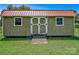 Close-up of shed with white double doors, windows, and a red metal roof at 4555 Us 601 Hwy, Salisbury, NC 28147