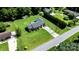Home with a well-manicured lawn, long driveway, and mature landscaping viewed from above at 50 Isenhour Park Rd, Taylorsville, NC 28681