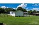 A well-maintained lawn surrounds a brick-accented home with a deck, enclosed by a chain-link fence at 50 Isenhour Park Rd, Taylorsville, NC 28681