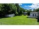 Spacious green backyard with detached sheds, offering ample space for outdoor enjoyment and storage at 50 Isenhour Park Rd, Taylorsville, NC 28681