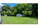 Large backyard with green grass and a detached shed, perfect for outdoor activities and extra storage at 50 Isenhour Park Rd, Taylorsville, NC 28681