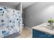 Well-lit bathroom featuring a floral shower curtain, a toilet, and a vanity with double sinks at 50 Isenhour Park Rd, Taylorsville, NC 28681