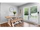 Cozy dining area with a wooden table, bench seating, and sliding glass doors to the outdoor space at 50 Isenhour Park Rd, Taylorsville, NC 28681