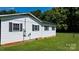 A beautiful home exterior with white vinyl siding, black shutters, and a well-maintained lawn at 50 Isenhour Park Rd, Taylorsville, NC 28681