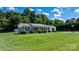 Charming brick home with a well-manicured lawn, mature trees, and a long driveway, set under a sunny sky at 50 Isenhour Park Rd, Taylorsville, NC 28681