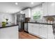 Modern kitchen featuring white cabinetry, granite countertops, stainless steel appliances, and hardwood floors at 50 Isenhour Park Rd, Taylorsville, NC 28681