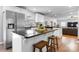 Bright kitchen with stainless steel appliances, granite countertops, and a breakfast bar with wooden stools at 50 Isenhour Park Rd, Taylorsville, NC 28681