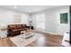 Bright living room boasts hardwood floors, a cozy leather sofa, and a decorative rug for added style at 50 Isenhour Park Rd, Taylorsville, NC 28681