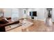 Inviting living room featuring hardwood floors, a comfortable leather sofa, and a stylish coffee table on an area rug at 50 Isenhour Park Rd, Taylorsville, NC 28681