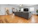 Inviting living room with a gray sectional sofa, hardwood floors, and views into other parts of the home at 50 Isenhour Park Rd, Taylorsville, NC 28681
