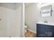 Bathroom featuring a shower, toilet, and a vanity with a dark blue cabinet at 5375 Eneida Sue Dr, Charlotte, NC 28214