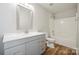 Clean bathroom featuring a modern vanity, shower and tub with sleek fixtures and vinyl floors at 5375 Eneida Sue Dr, Charlotte, NC 28214