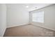 Minimalist bedroom design with neutral carpet, and a well-lit atmosphere from the bright window at 5375 Eneida Sue Dr, Charlotte, NC 28214