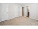 An open bedroom boasts neutral walls, carpeted floors and white doors at 5375 Eneida Sue Dr, Charlotte, NC 28214