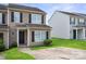 Townhouse featuring black shutters and a well-maintained lawn at 5375 Eneida Sue Dr, Charlotte, NC 28214