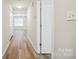 Hallway featuring wood floors, white trim and plenty of natural light at 5375 Eneida Sue Dr, Charlotte, NC 28214