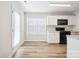 Well-lit kitchen with modern appliances and light countertops, complemented by hardwood floors at 5375 Eneida Sue Dr, Charlotte, NC 28214