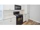 Bright kitchen with black appliances, granite countertops, and white cabinetry at 5375 Eneida Sue Dr, Charlotte, NC 28214