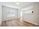 Bright living room featuring hardwood floors, and abundant natural light from the large window at 5375 Eneida Sue Dr, Charlotte, NC 28214