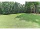 Expansive view of lush green backyard surrounded by mature trees offers tranquil outdoor living at 5890 Alley Rd, Catawba, NC 28609