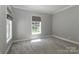 Bright, spacious bedroom with plush carpet, neutral paint, and a window offering exterior views at 5890 Alley Rd, Catawba, NC 28609