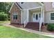 Close up of front entrance with white trim, stone accents, and a well maintained lawn at 5890 Alley Rd, Catawba, NC 28609