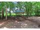Wood gazebo with built-in bench swing seating nestled amongst the trees in a private area at 5890 Alley Rd, Catawba, NC 28609