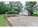 View of the outbuilding with double doors and a carport with ample parking on a gravel driveway at 5890 Alley Rd, Catawba, NC 28609