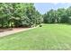 View of the yard with trees and path to a lush, serene wooded property at 5890 Alley Rd, Catawba, NC 28609