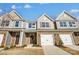 Charming townhomes with stone accents, attached garages, and well-manicured lawns offer modern living at 6274 Tea Olive Dr # 237, Harrisburg, NC 28075