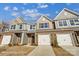 Charming townhomes with stone accents, attached garages, and well-manicured lawns offer modern living at 6274 Tea Olive Dr # 237, Harrisburg, NC 28075