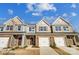 Charming townhomes with stone accents, attached garages, and well-manicured lawns offer modern living at 6274 Tea Olive Dr # 237, Harrisburg, NC 28075