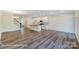 Open-concept living space with island kitchen, hardwood floors, and abundant natural light creates an airy feel at 6274 Tea Olive Dr # 237, Harrisburg, NC 28075